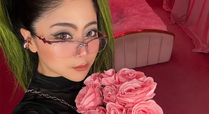 RayRay, the EDM artist, posing with pink roses to promote her new song "Feeling Better," which is effective music for feeling better.