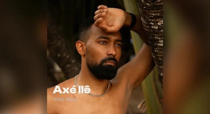 Tone Rich Axé Ilê album cover featuring the artist in a natural outdoor setting.
