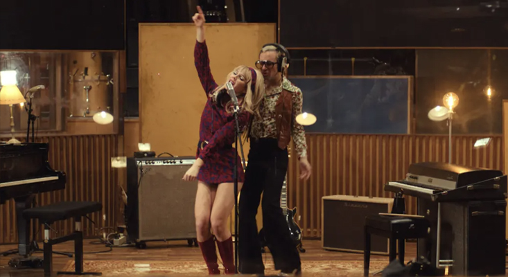 Sam Quealy and Marlon Magnée in 70s fashion dancing in a vintage recording studio for By My Side music video.
