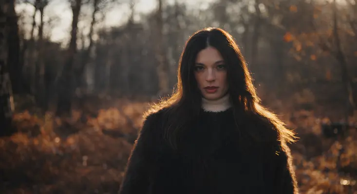 Veronica Largiu Brings Indie Pop Rock To Life In “Survival Instinct” Veronica Largiu standing in a sunlit forest for her Survival Instinct indie pop rock music video.