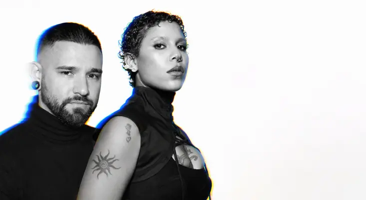 Skrillex and Tokischa posing back to back in black and white for their new reggaeton single Surfboard.