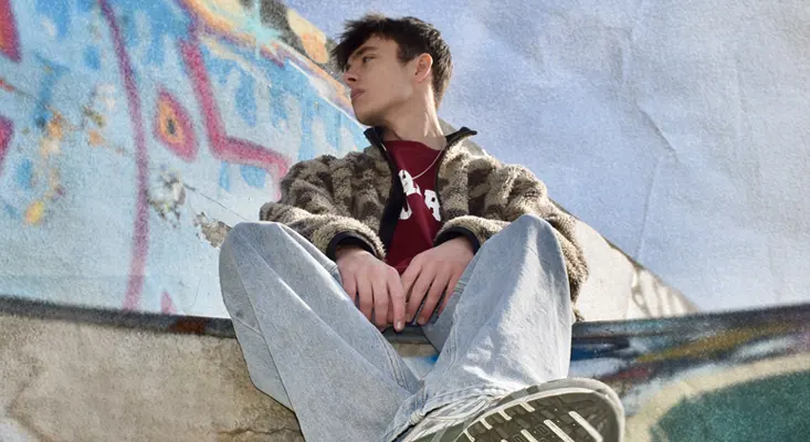 UK producer Jøsh sitting outdoors, artist profile for the cinematic club weapon ASCEND.