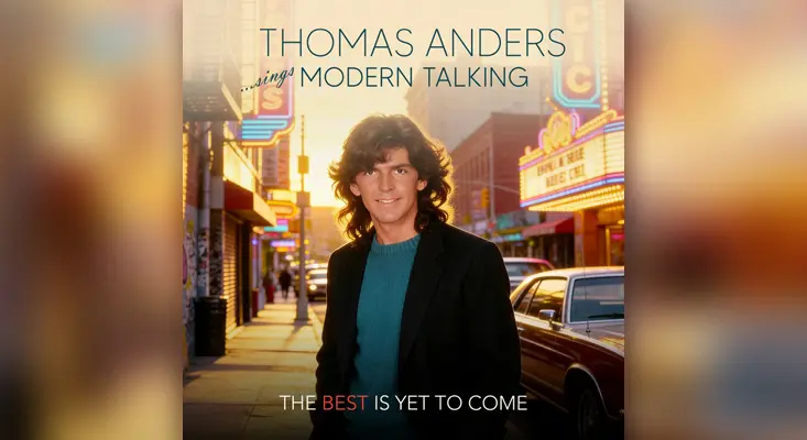Thomas Anders posing in a city street with neon signs for his single The Best Is Yet To Come.