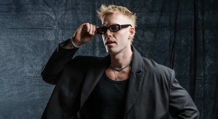 Will Sparks new song Bad Girls promo photo featuring the artist in a black suit and sunglasses.