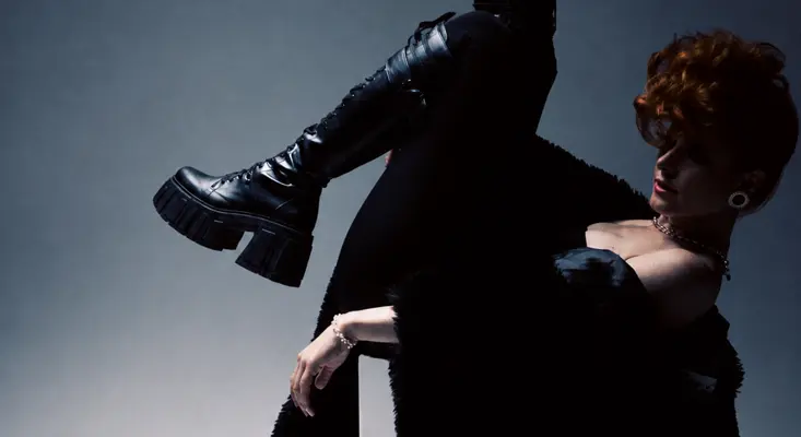 Canadian singer-songwriter Kiesza poses dramatically in a black outfit and platform boots for When Im Dancing single.