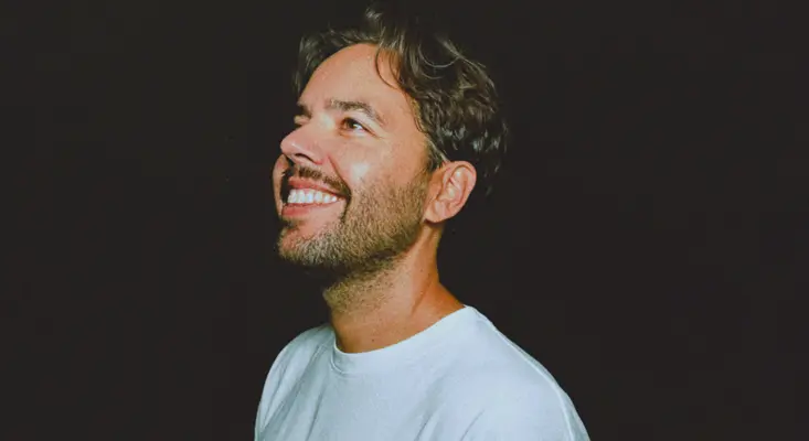 Dutch producer Helsloot smiling in a profile shot against a black background, announcing his 2026 North American solo tour.