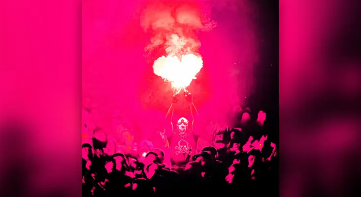 Official cover art for A Thousand Lies by DJ HEARTSTRING, DMA'S, and Saidah, featuring a crowd under high-energy pink lights with a heart-shaped flare capturing electronic music Trance vibes.