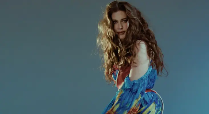 Jessie Altman in flowing blue dress, glancing back for her true love song "Barcelona."