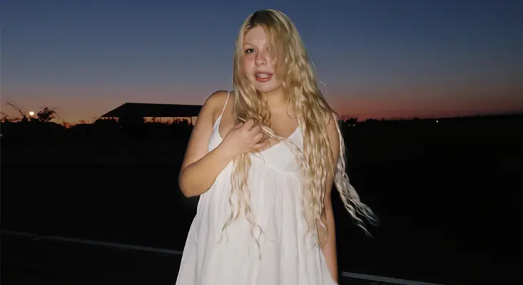 From LA To Nashville: Inside Shaelyn Avalon’s Musical Reinvention Shaelyn Avalon poses in a white dress at sunset for her Nashville Country Rock interview.