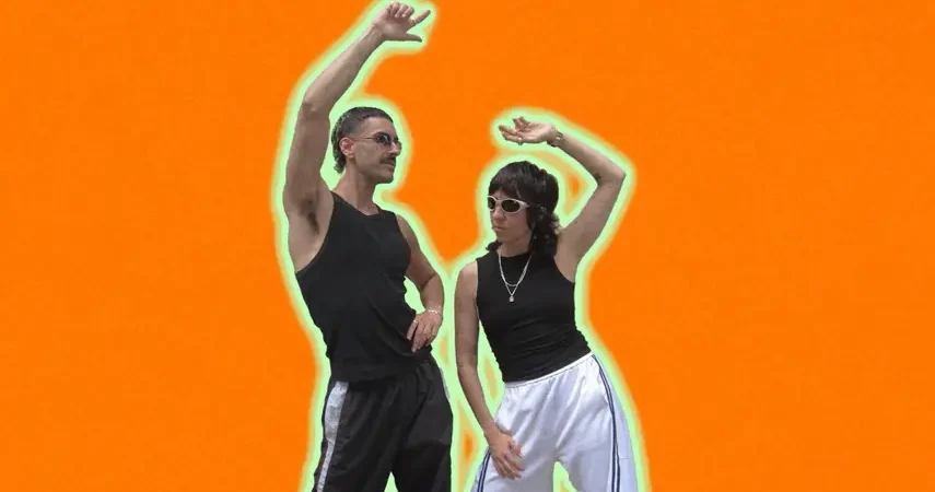Luke Alessi and Chloé Caillet posing in athletic wear in front of a bright orange background for their Acid House music release Change.