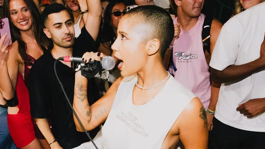 Tokischa commands the crowd during a live performance, embodying the bold, unapologetic energy behind her EDM Latin collab with Major Lazer.