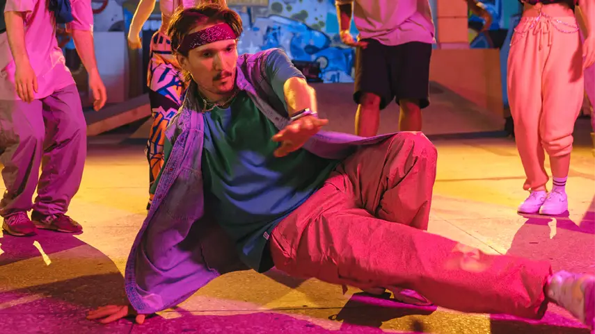 Hip-Hop fashion encourages individuality, confidence, and self-expression by inspiring people to create their own unique style. Breakdancer wearing Hip-Hop streetwear expressing individuality through fashion and dance in an urban setting.
