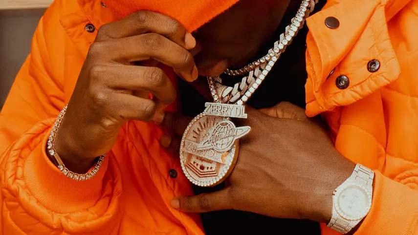 Jewelry in Hip-Hop fashion represents achievement, confidence, and personal success while reflecting creativity and cultural identity. Hip-Hop artist wearing diamond chains and luxury jewelry symbolizing success, achievement, and self-expression.