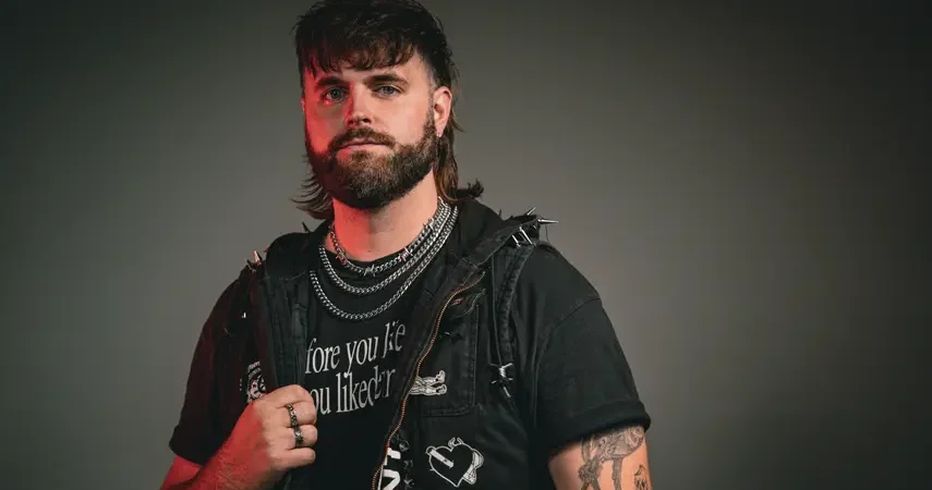 Press photo of Micah Martin posing in a studded vest for his debut album All I Need.