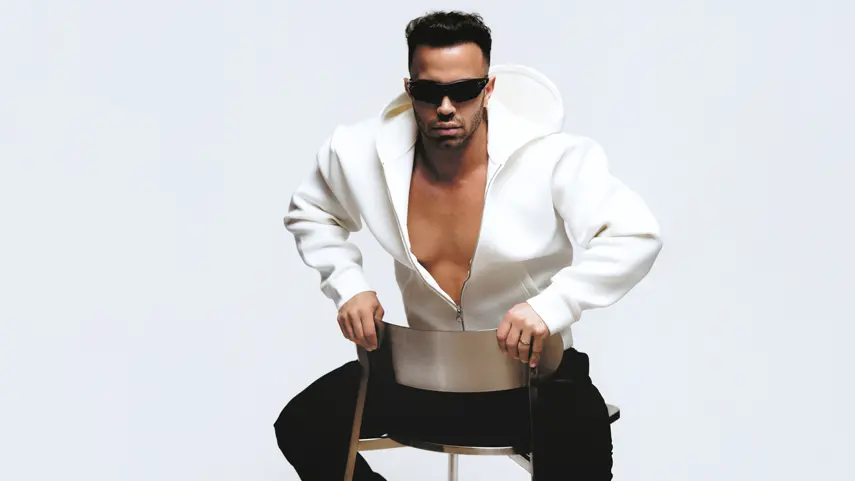 On Mekahel wearing a white hoodie and sunglasses while promoting his Electro-Pop single "Pu$$y."