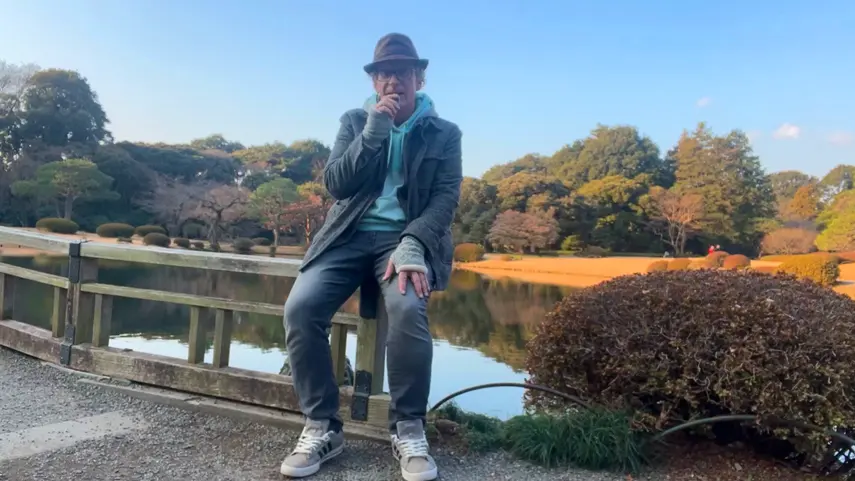 Chris Kramer Is Son Tensei: Spiritual Rebirth, Japan & New Music Chris Kramer, known as Son Tensei, sitting by a pond in a Japanese garden.