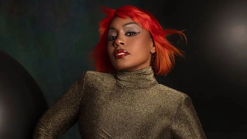 Ultra Naté’s “Free” Started It All; Now, “Movin’ To The Sun” Tops Beatport Ultra Naté Free singer with red hair and gold outfit promoting Movin' To The Sun