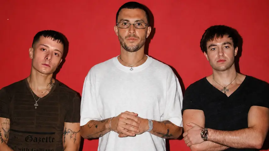 Cloonee and Prospa pose together against a red backdrop for the "Good Girl" single release.