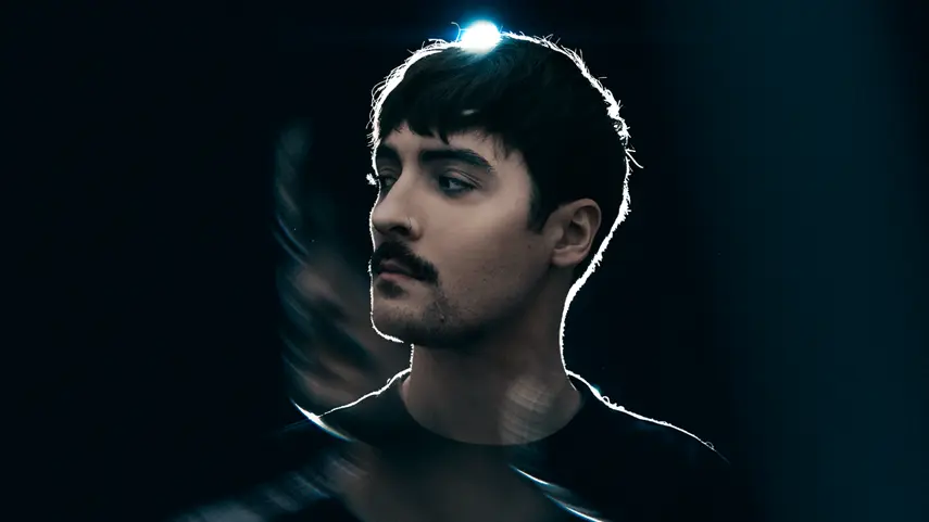 Justin Hawkes Returns With Second DnB Album ‘Now Or Never’ Justin Hawkes poses in dramatic backlight for his DnB album Now Or Never.