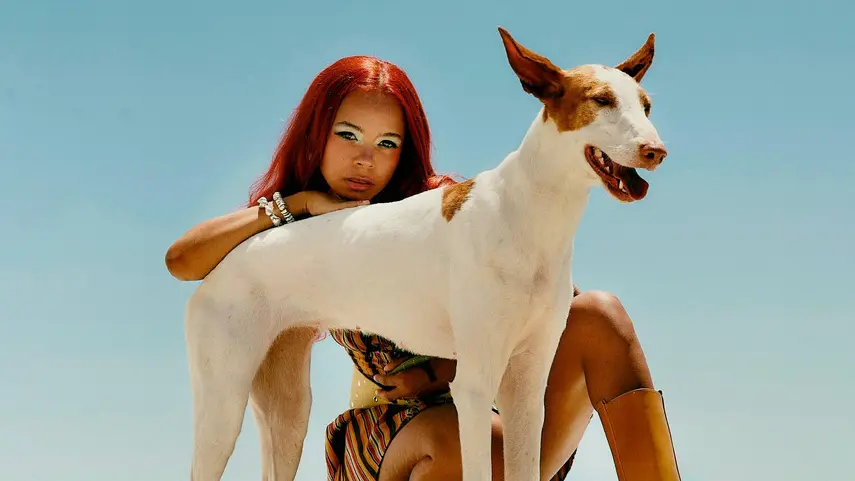 TSHA Goes Old School House On Her New Track “Tell Me” TSHA poses with an Ibizan hound on a beach for her new single Tell Me.