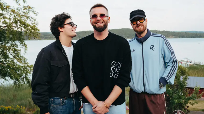 Topic and carteblanche pose together outdoors by a lake ahead of "Lucky Ones" release.