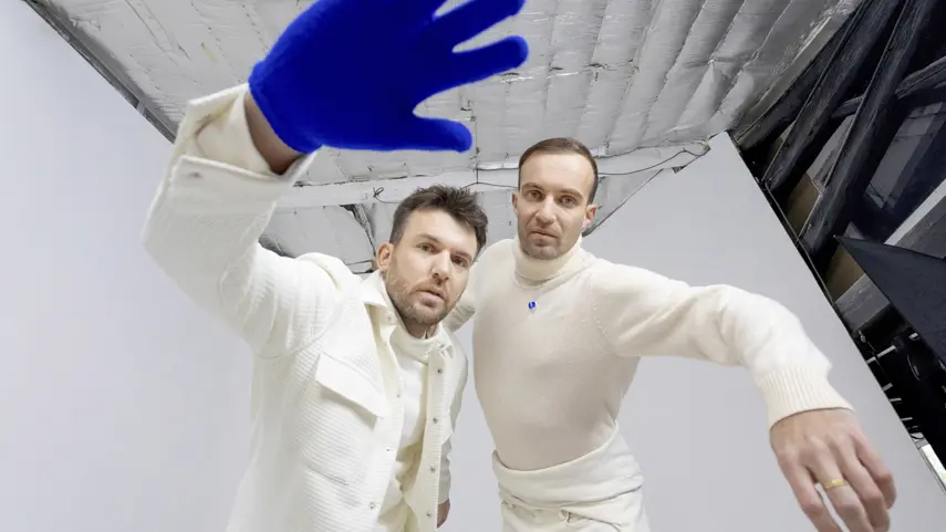 il:lo Open Up About 'Lucent,' Cinematic Sounds, And Emotions il:lo duo Dejan Dejado and Andreas Schütz posing in white outfits for Lucent interview.