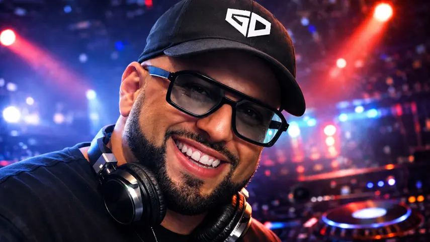 Grammy nominated producer Giuseppe D smiling in black cap and glasses at DJ booth for ULTRAFOCUS dance music album review.