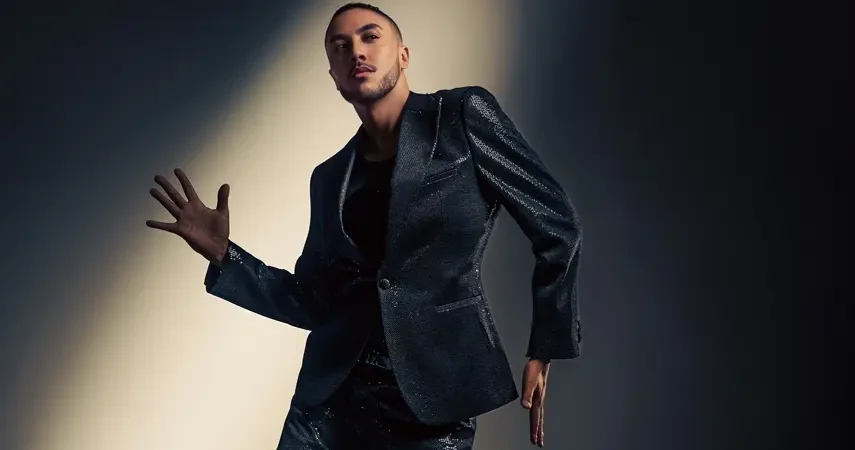 Dominique poses in a sequined black suit for his debut single "You're a Star (Get on Up)".