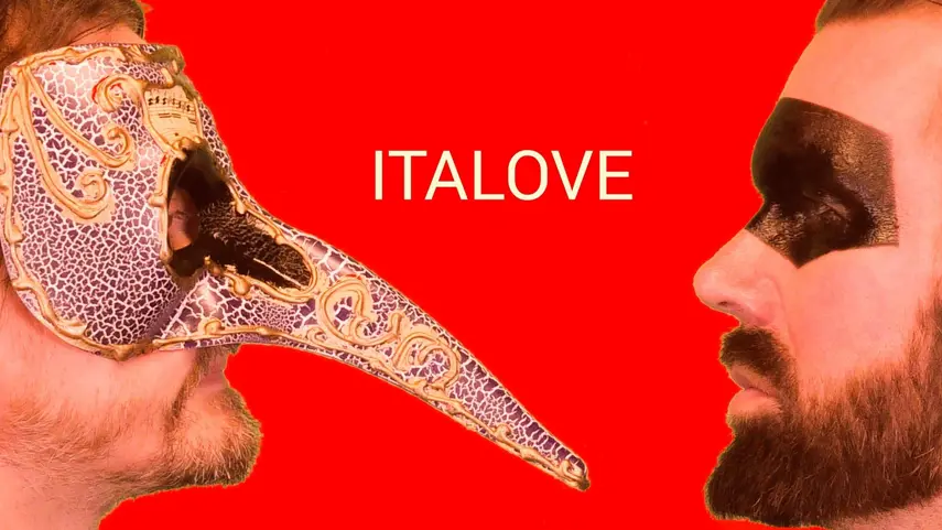 Italove press photo with the duo face to face, one wearing a Venetian bird mask, the other in black eye makeup, against a red background.