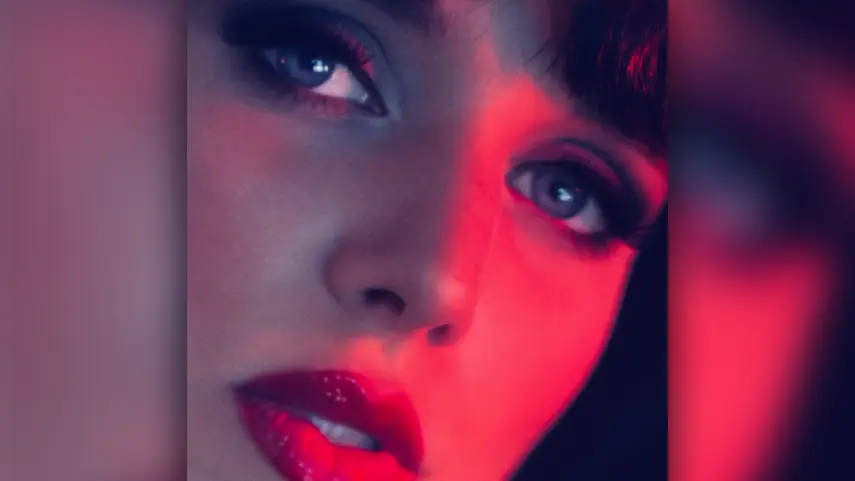 Close-up cover art for Desire's "Just Another Love Song" featuring Megan Louise bathed in red neon light.