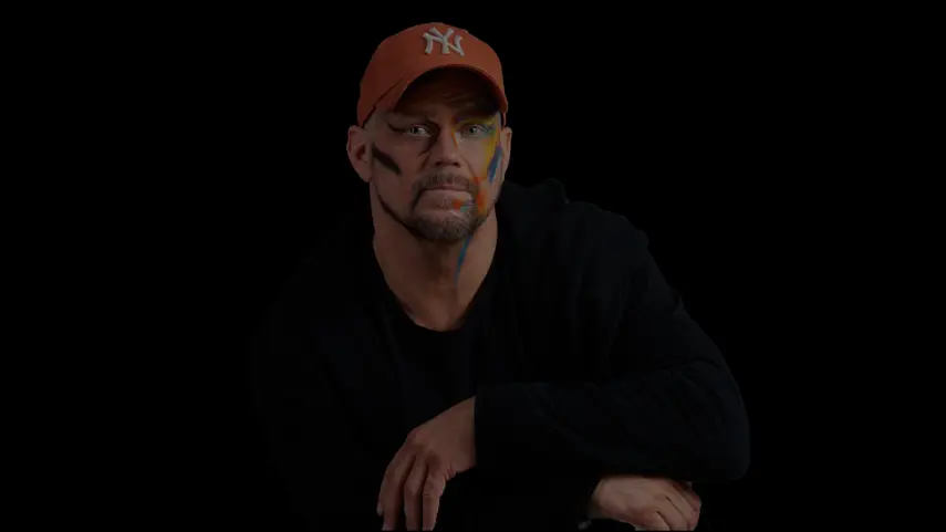 Overthinking Anxiety Feels So Real In COY Swede’s New Song Swedish Pop artist COY Swede wearing a NY baseball cap with colorful face paint in a music video screenshot for his song Circles Round This Town.
