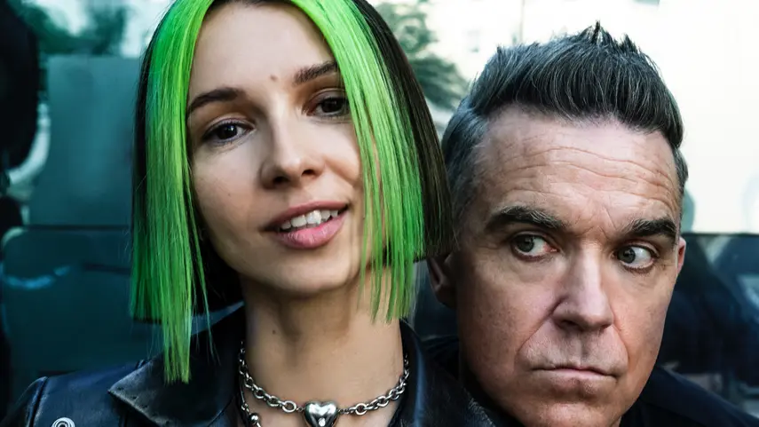 Robbie Williams Flirts With EDM: “Beauty In Us” By Miss Monique Robbie Williams and Miss Monique pose together for "Beauty In Us" collaboration.