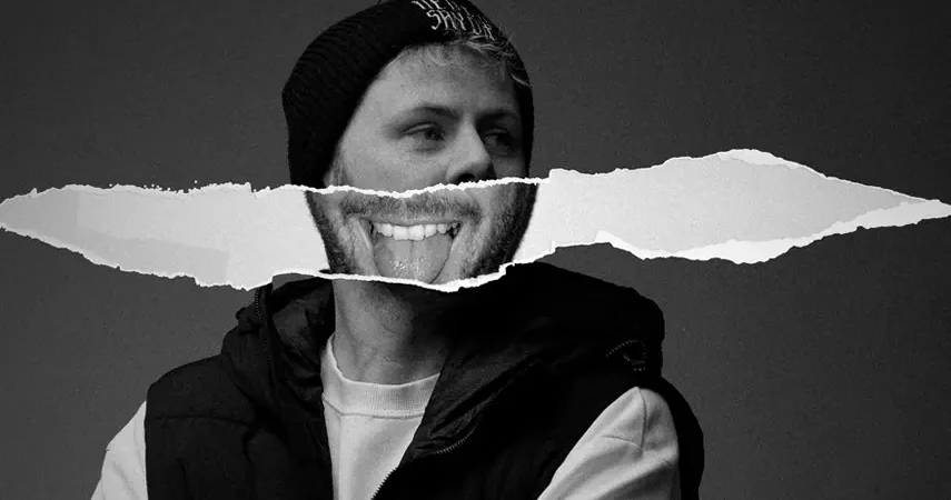 Black and white press photo of Dubstep producer Spag Heddy wearing a beanie with a ripped paper photo collage effect across his face.