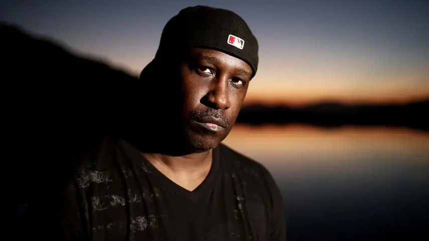 Todd Terry, the DJ and producer behind the "Whiskey Blues" Freeze Mix. Todd Terry wearing a black beanie in a moody sunset portrait by the water.
