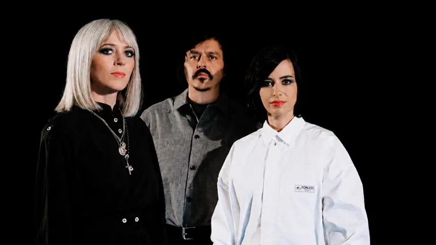Ladytron Helen Marnie press photo with three band members posing against a black background for Free, Free.