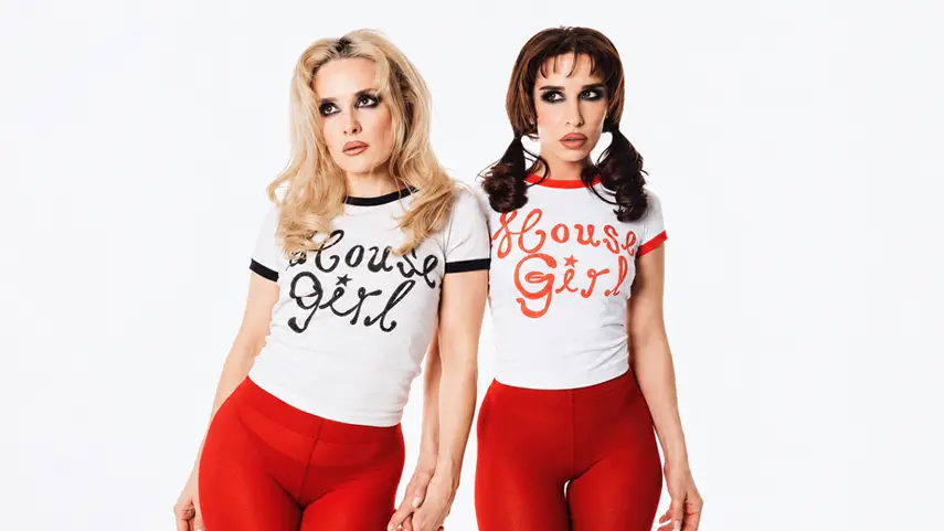 Scandinavian duo Rebecca & Fiona posing in white “House Girl” tees and red leggings.